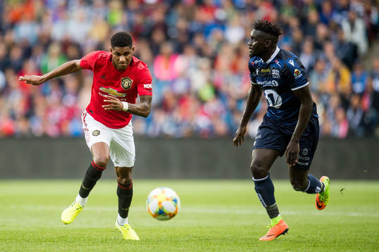 Marcus Rashford of Manchester United and Aliou Coly of