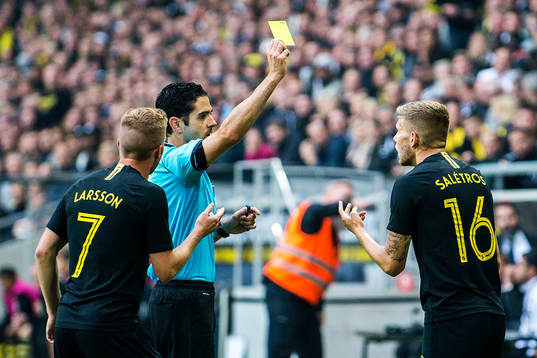 Anton Salétros of AIK gets a yellow card