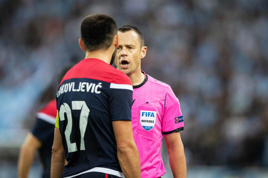 referee Stuart Attwell in discussion with Slobodan