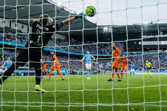 Markus Rosenberg of Malmö FF scores 1-0 behind goalkeeper