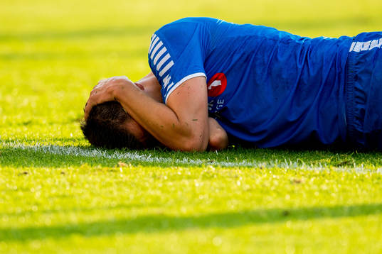 Jostein Gundersen of Tromsø lies down with an injury