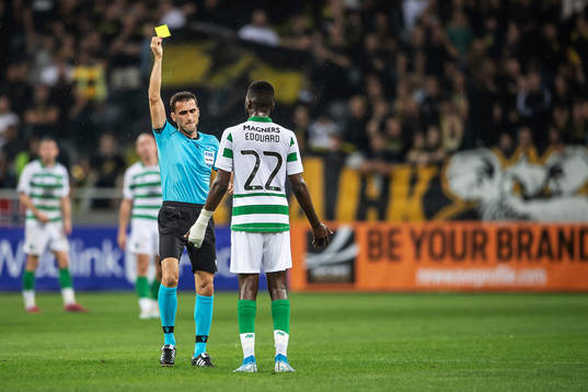 referee Nikola Dabanovic shows a yellow card to Odsonne