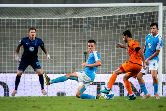 Avishay Cohen of Bnei Yehuda shoots at Jonas Knudsen and