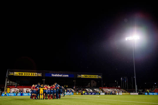 Players and staff of Norway gather in a circle