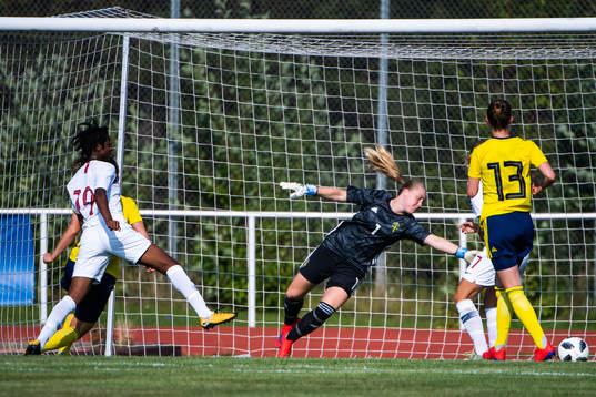 Joshualyn Revees of Norway scores 1-0 behind goalkeeper