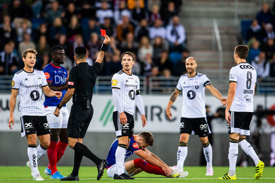 Mike Jensen of Rosenborg is shown a red card from Rohit