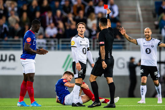 Mike Jensen of Rosenborg is shown a red card from Rohit