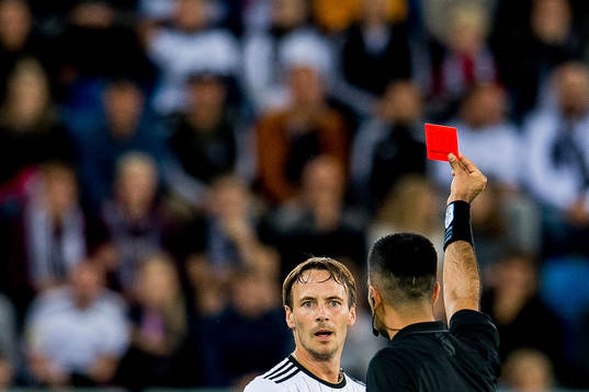 Mike Jensen of Rosenborg receives a red card from referee