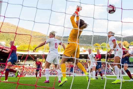 Frida Maanum of Norway scores 1-1 behind goalkeeper Carly