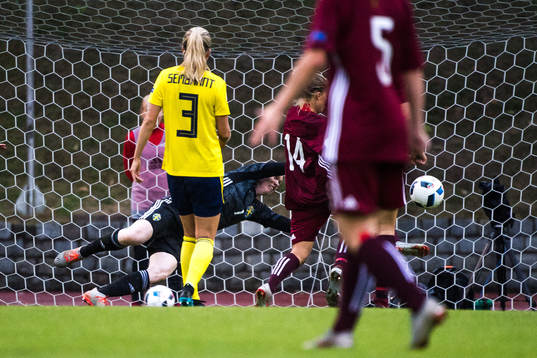 Olga Sevcova of Latvia scores the 1-0 goal behind