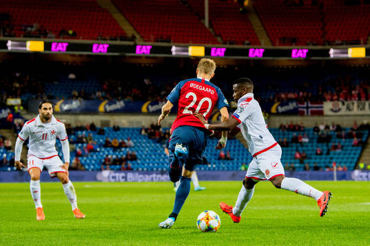 Martin Ødegaard of Norway and Joseph Mbong of Malta