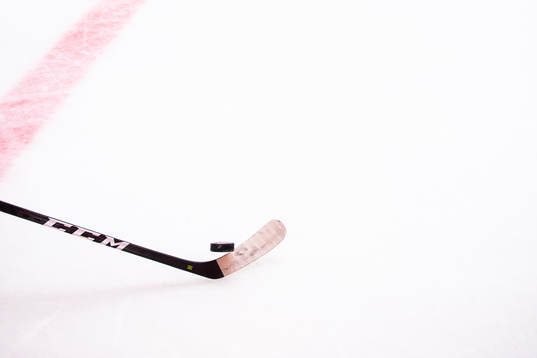 A general picture of a hockey stick and a puck