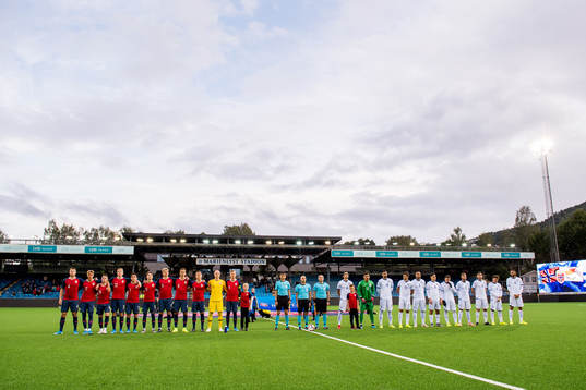 The players of Norway and of Cyprus line up