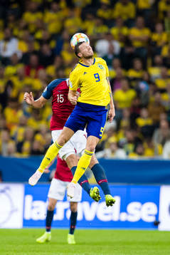 Marcus Berg of Sweden wins a header against Sander Berge of