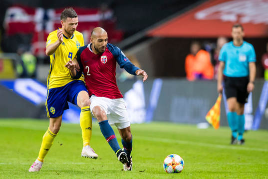 Marcus Berg of Sweden battles for the ball with Haitam