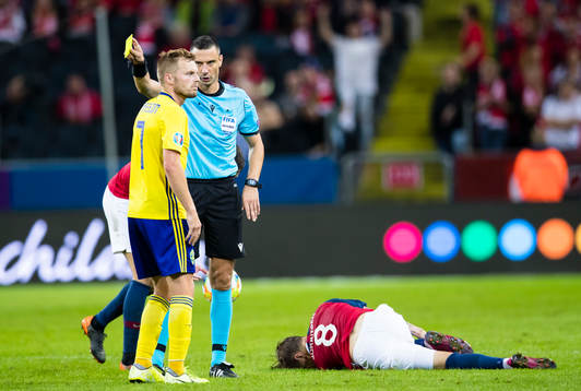 Referee Slavko Vincic with a yellow card to Sebastian