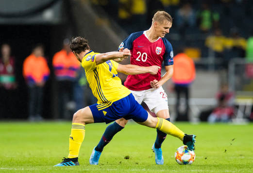 Gustav Svensson of Sweden battles for the ball with Martin