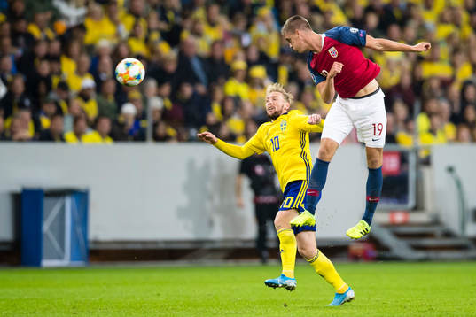 Emil Forsberg of Sweden battles for the ball with  Markus