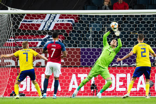 Goalkeeper Robin Olsen of Sweden saves a header from Joshua