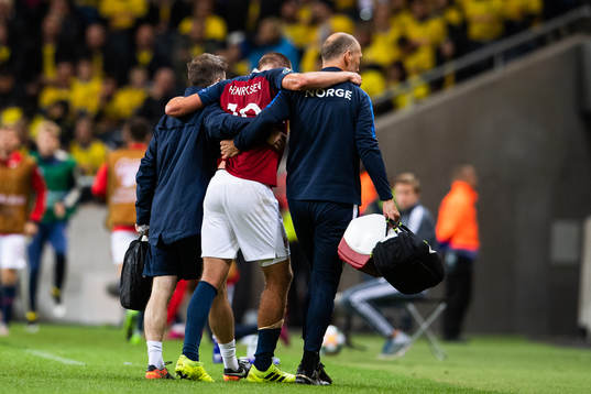 Markus Henriksen of Norway receives help leaving the pitch