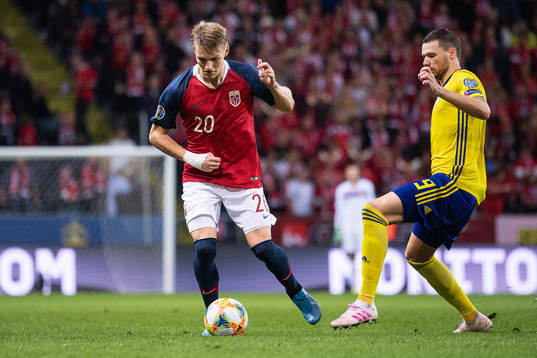 Martin Ødegaard of Norway and Marcus Berg of Sweden