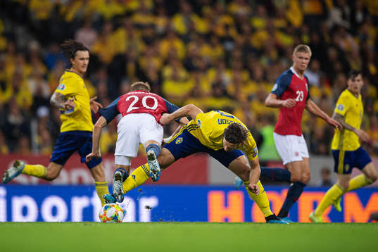 Martin Ødegaard of Norway is being tripped by Gustav