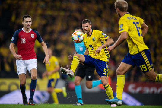 Marcus Berg of Sweden passes the ball to Sebastian Andersson