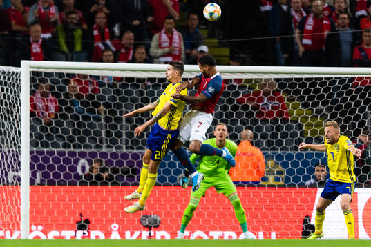 Mikael Lustig of Sweden and of Norway Joshua King compete