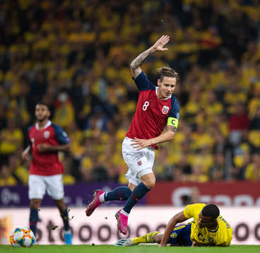 Stefan Johansen of Norway tackles Robin Quaison of Sweden