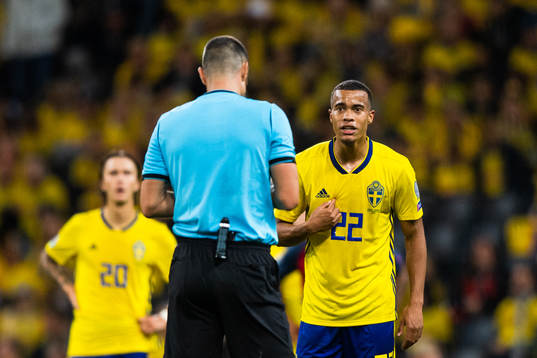 Referee Slavko Vincic and Robin Quaison of Sweden