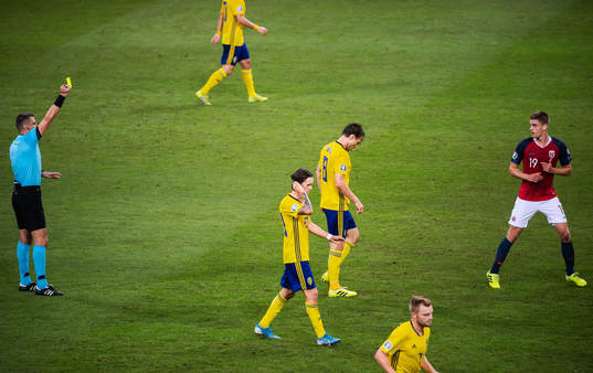 Markus Henriksen of Norway receives a varning from referee