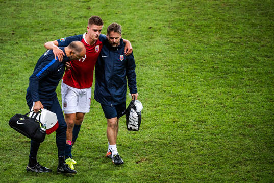 Markus Henriksen of Norway receives help of the pitch