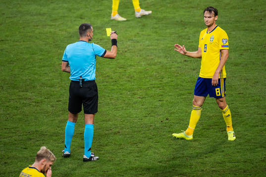 Albin Ekdal of Sweden receives a varning from referee