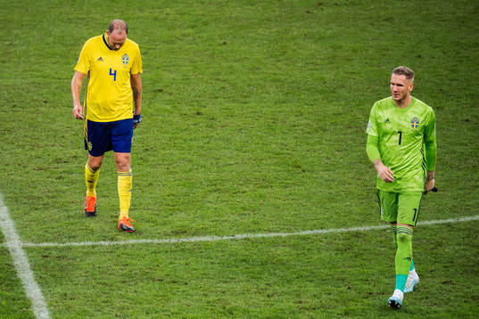 Andreas Granqvist and goalkeeper Robin Olsen of Sweden look