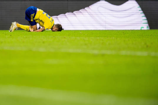 Mikael Lustig of Sweden lies down with an injury