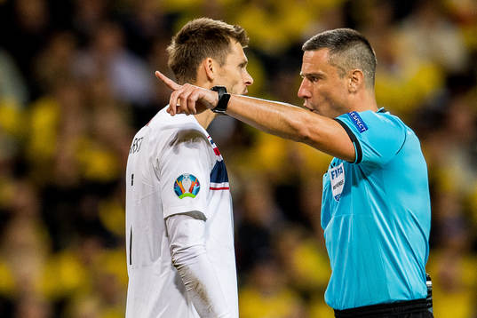 Goalkeeper Rune Almenning Jarstein of Norway and referee
