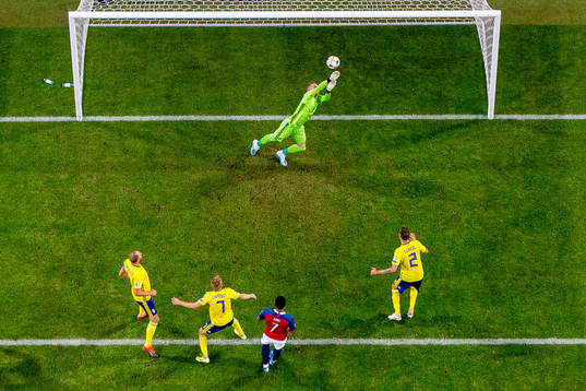 Goalkeeper Robin Olsen of Sweden saves the attempt from
