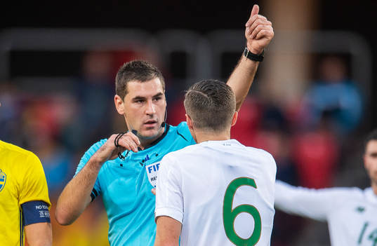 Referee Rade Obrenovic and Conor Coventry of Ireland