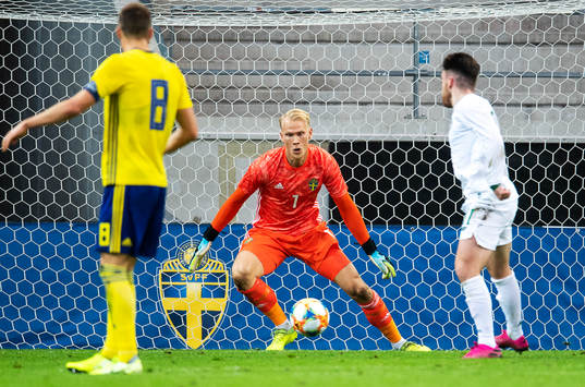Goalkeeper Pontus Dahlberg of Sweden and Aaron Connolly of