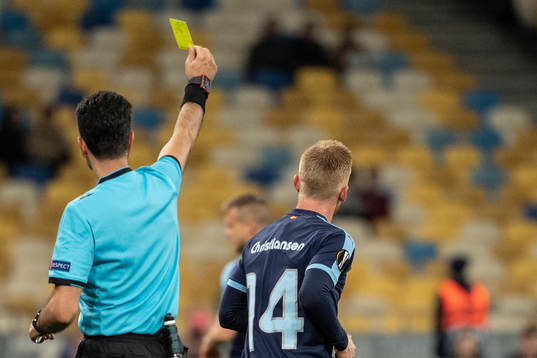 Anders Christiansen of Malmö FF receives a yellow card