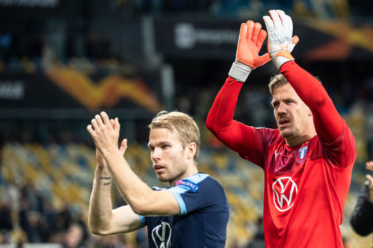 Oscar Lewicki and goalkeeper Johan Dahlin of Malmö FF