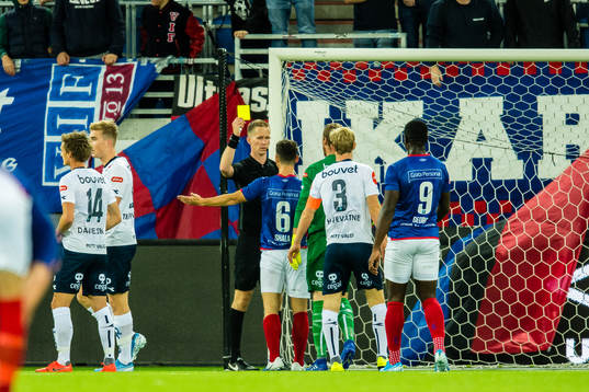Herolind Shala of Vålerenga gets a yellow card by