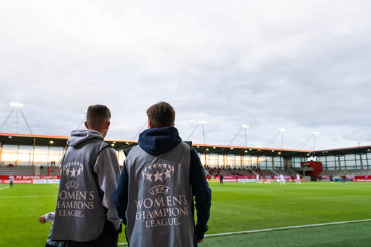 Two boys wearing UEFA Women’s Champions League vests