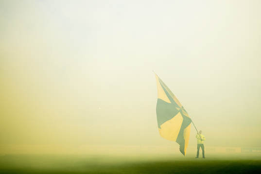 A guard holds the flag of Bodø/Glimt
