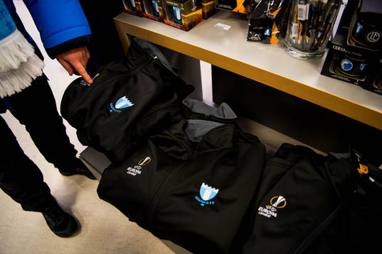 Visitors look at sweatshirts with the logo of Malmö FF and