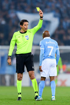 Referee Deniz Aytekin shows a yellow card