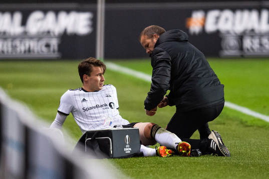 Anders Trondsen of Rosenborg receives medical attention due