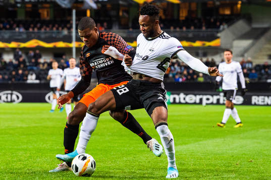Denzel Dumfries of PSV Eindhoven and Samuel Adegbenro