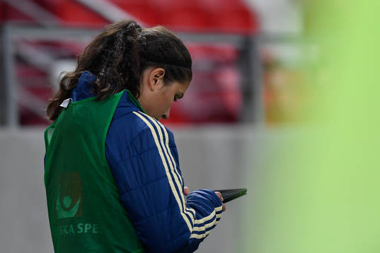 Loreta Kullashi of Sweden looks at her phone