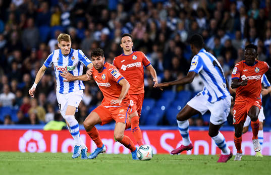 Martin Odegaard of Real Sociedad battles for the ball with